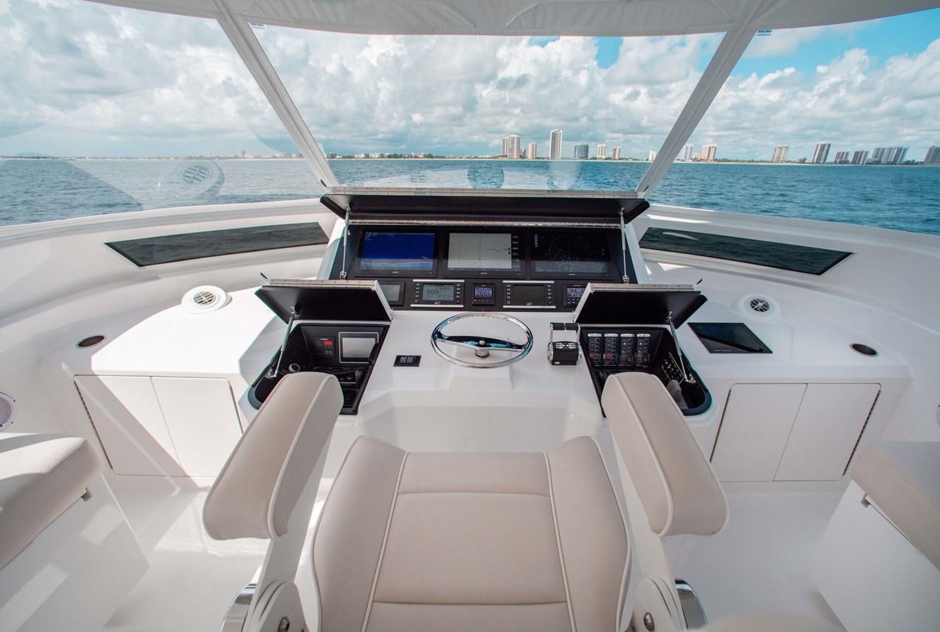 inside of a white car with a large window and a view of the city below aboard NEW VIKING 82 COCKPIT MOTOR YACHT Yacht for Sale