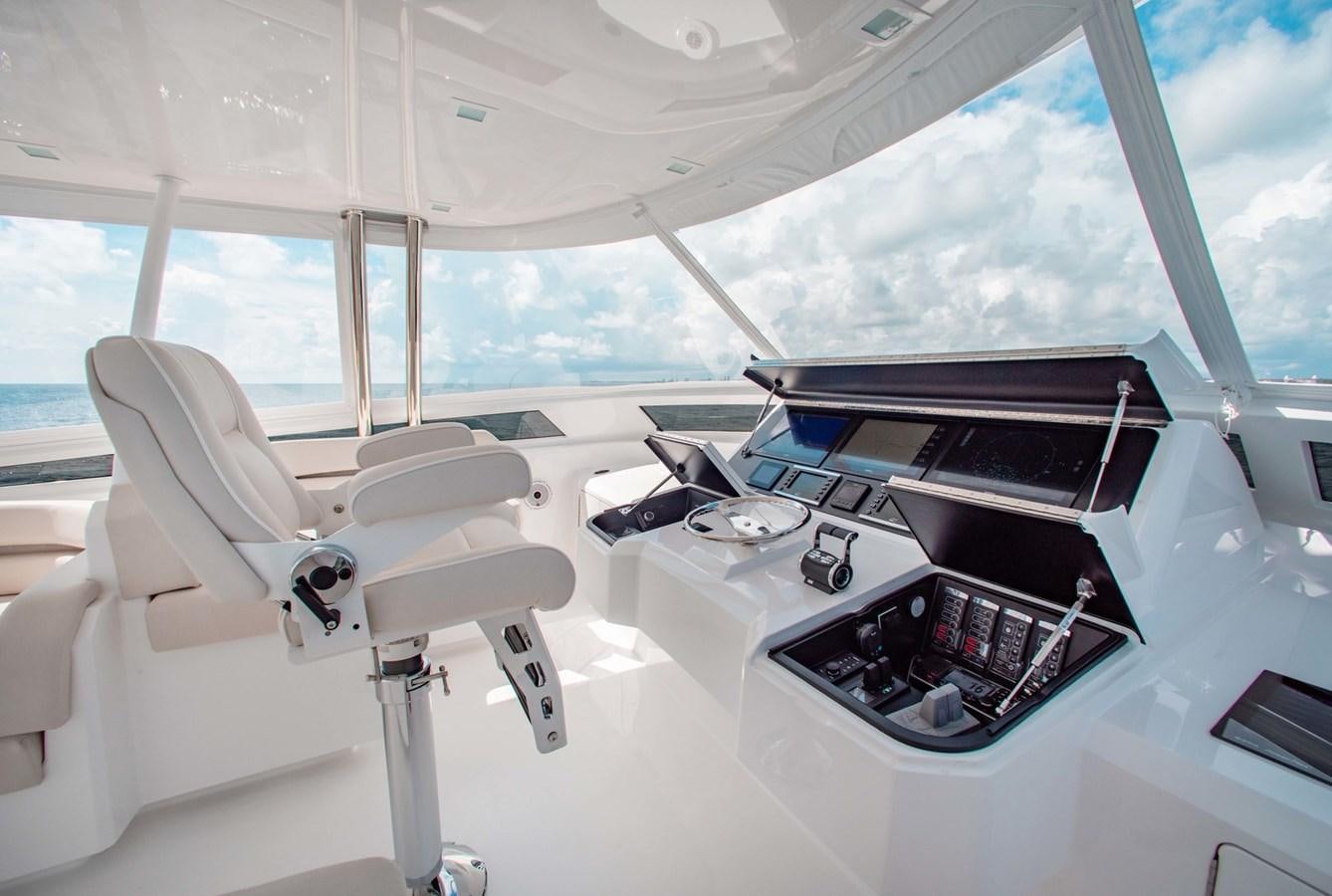 a white chair in a room aboard NEW VIKING 82 COCKPIT MOTOR YACHT Yacht for Sale