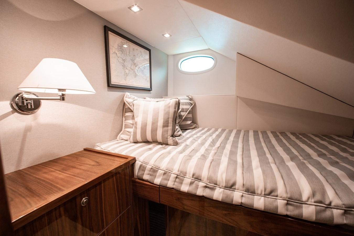 a bed with a striped sheet aboard NEW VIKING 82 COCKPIT MOTOR YACHT Yacht for Sale