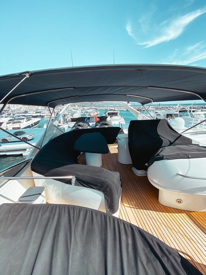 a deck with a view of a marina and boats aboard HELENA Yacht for Sale