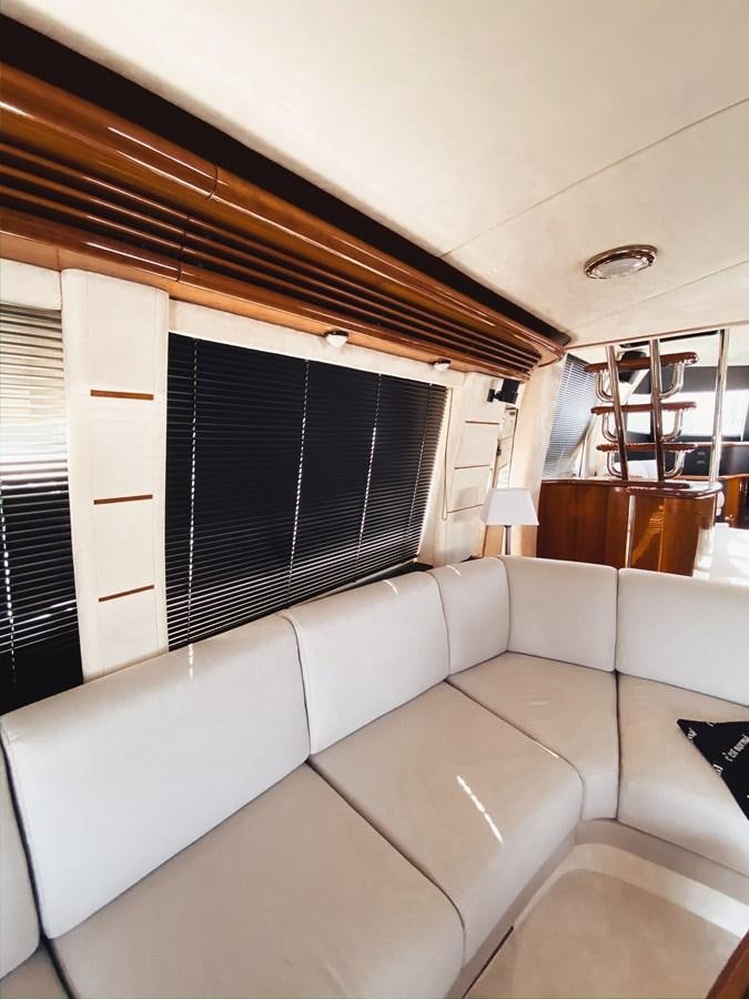 a room with a couch and a window aboard HELENA Yacht for Sale
