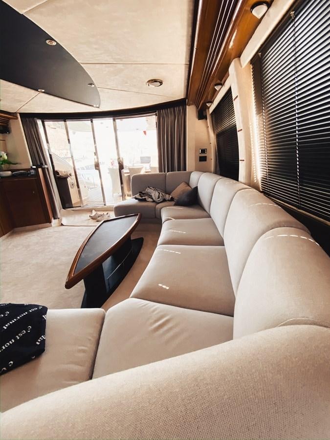 a living room with a couch and a table aboard HELENA Yacht for Sale