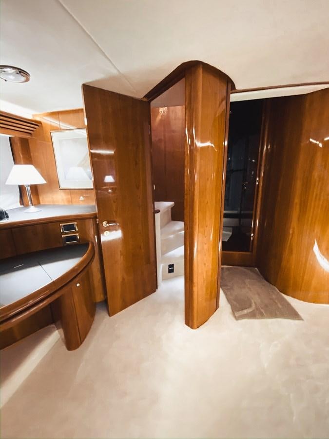 a bathroom with a wood door aboard HELENA Yacht for Sale