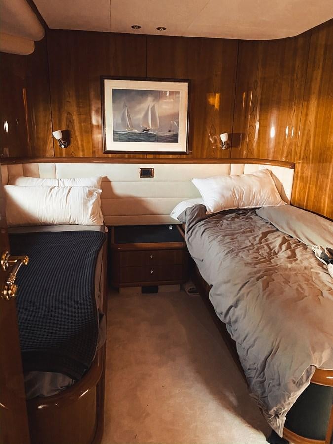a hotel room with two beds aboard HELENA Yacht for Sale