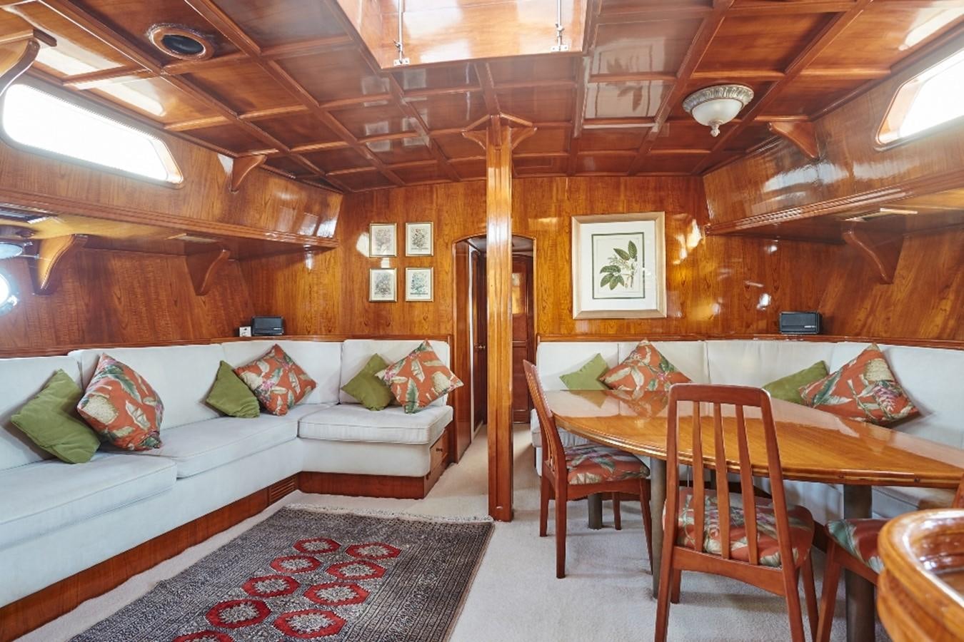 a living room with a couch and a table aboard SLOW DANCE Yacht for Sale