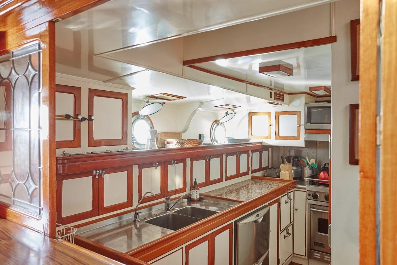 a kitchen with wooden cabinets aboard SLOW DANCE Yacht for Sale