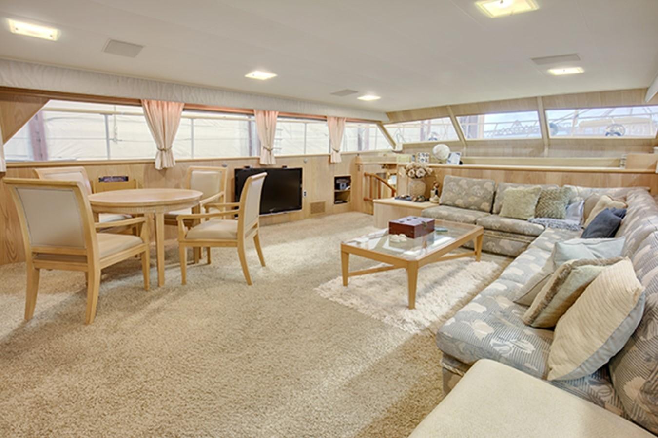 a living room with a couch and a television aboard EXCALIBUR Yacht for Sale