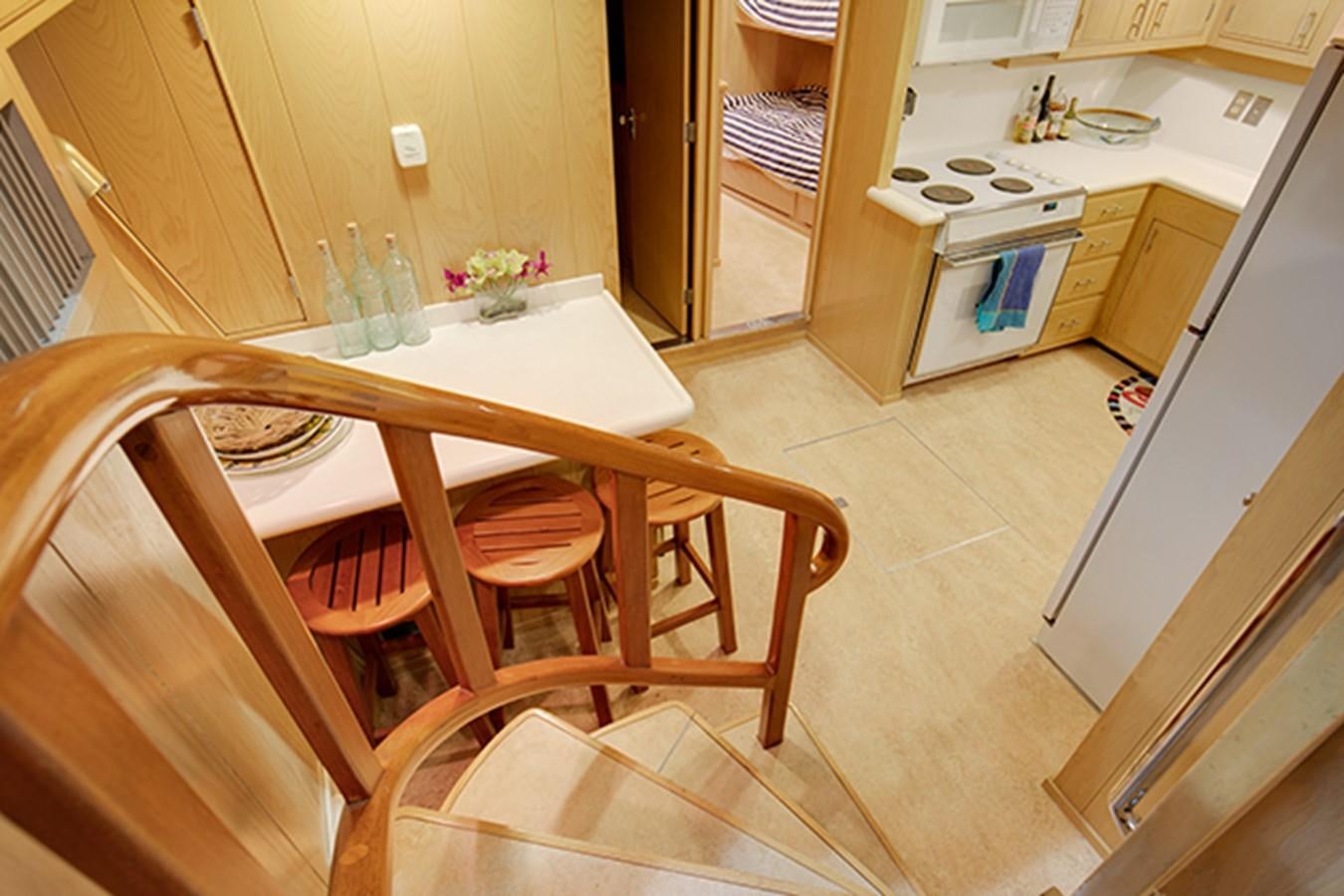 a kitchen with a dining table aboard EXCALIBUR Yacht for Sale