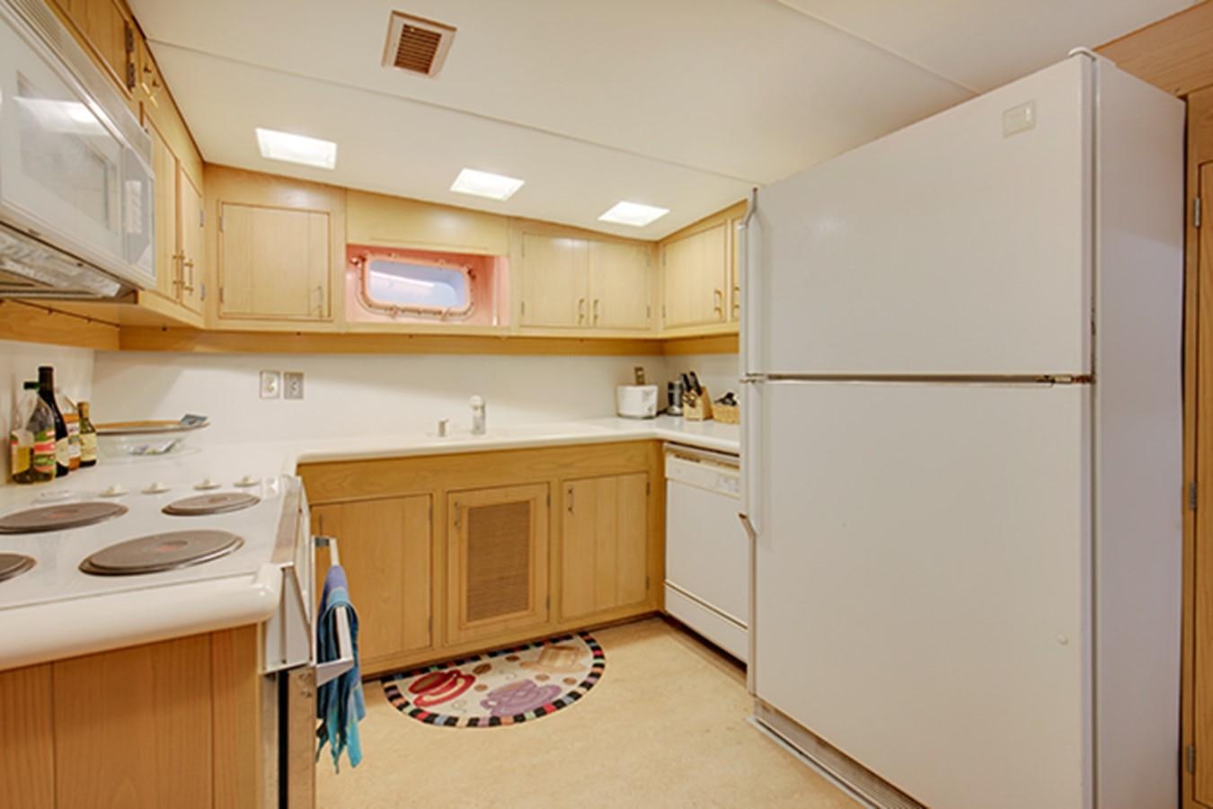 a kitchen with white appliances aboard EXCALIBUR Yacht for Sale