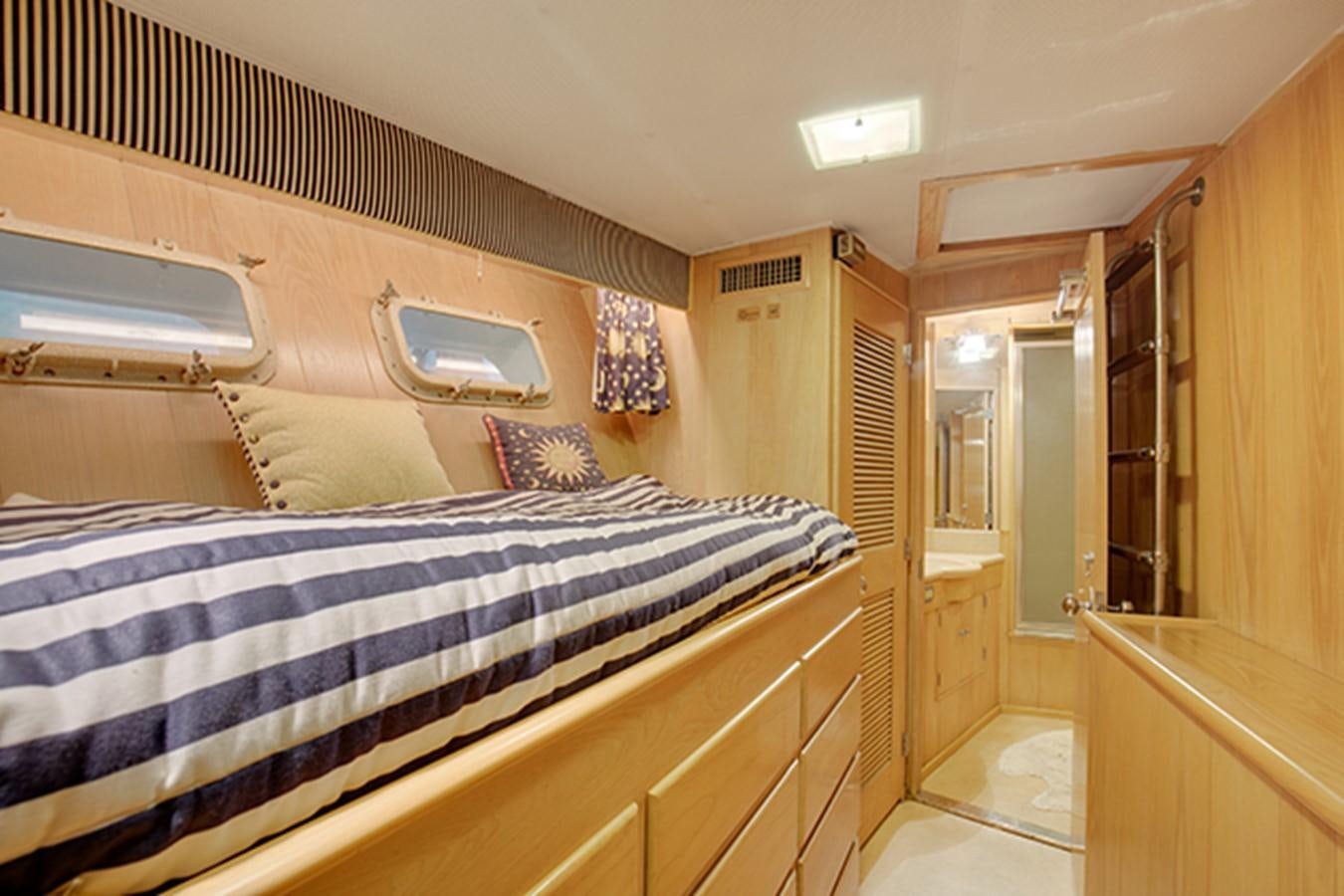 a bedroom with a bed and a closet aboard EXCALIBUR Yacht for Sale