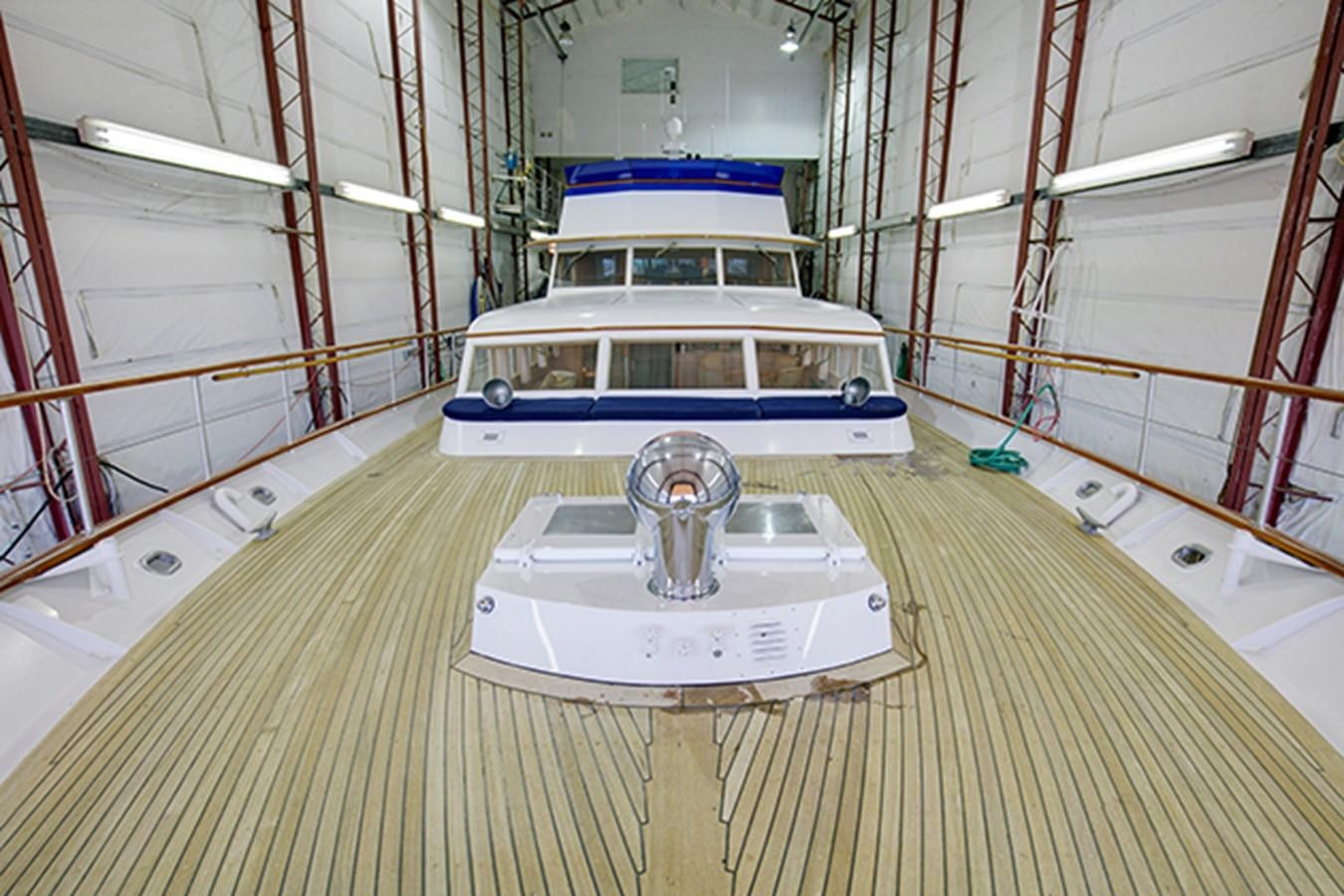 a white and blue boat in a large room aboard EXCALIBUR Yacht for Sale