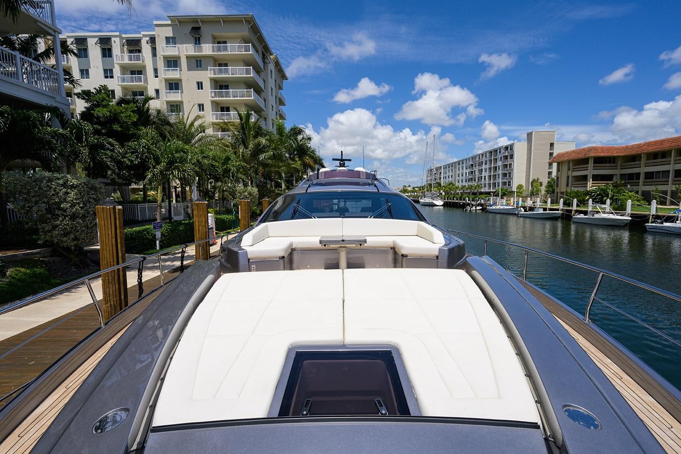 a white boat on a body of water with buildings in the background aboard ON THE MOVE Yacht for Sale
