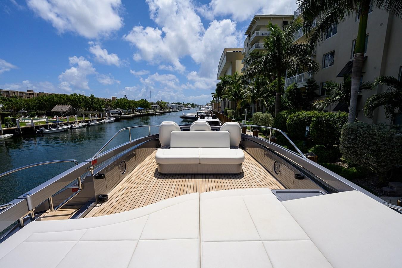 a white lounge chair on a deck overlooking a body of water aboard ON THE MOVE Yacht for Sale