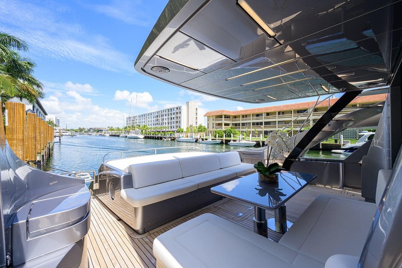 a large white lounge chair next to a pool and a large building aboard ON THE MOVE Yacht for Sale
