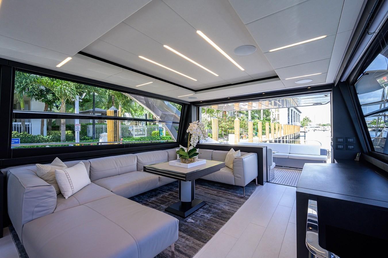 a room with a couch and a table and a window aboard ON THE MOVE Yacht for Sale