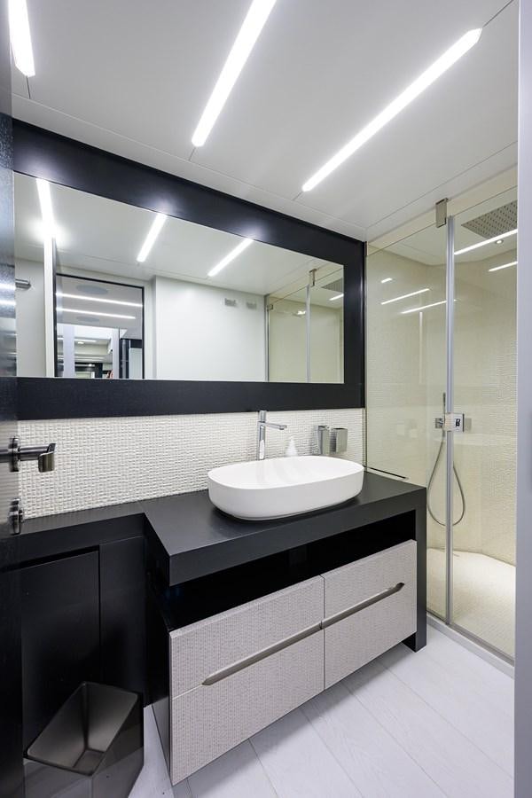a bathroom with a large mirror aboard ON THE MOVE Yacht for Sale