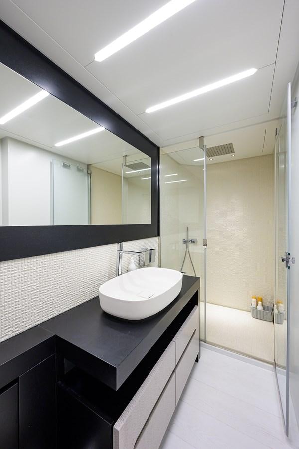 a bathroom with a sink and a shower aboard ON THE MOVE Yacht for Sale