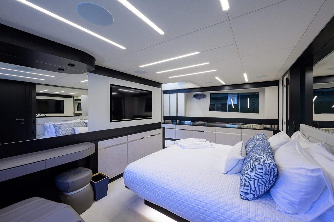 a room with a bed and a television aboard ON THE MOVE Yacht for Sale