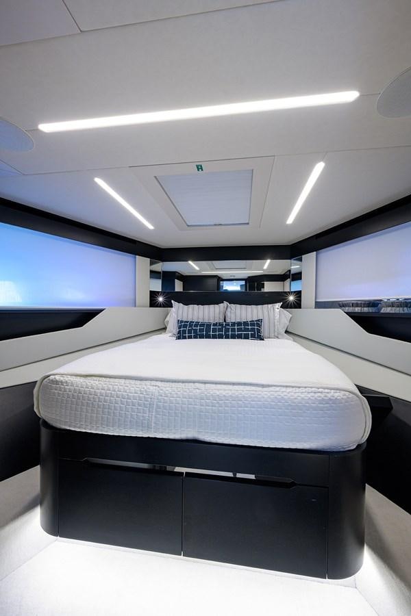 a room with a bed and a tv on the wall aboard ON THE MOVE Yacht for Sale