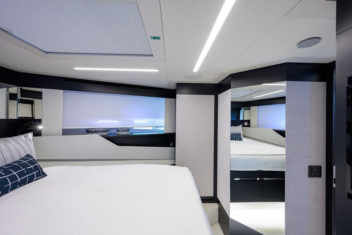 a room with a bed and a large screen aboard ON THE MOVE Yacht for Sale