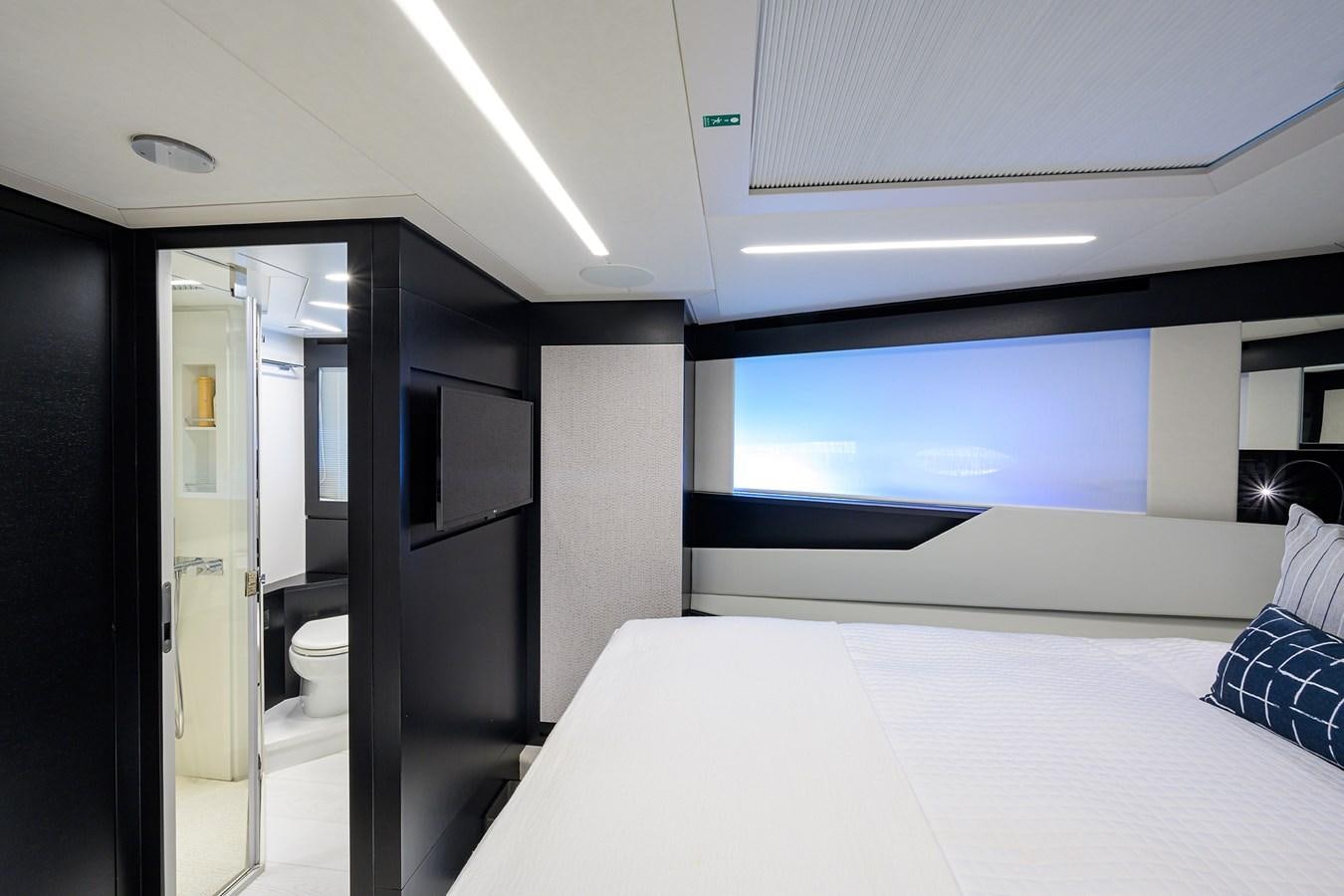 a room with a bed and a window aboard ON THE MOVE Yacht for Sale