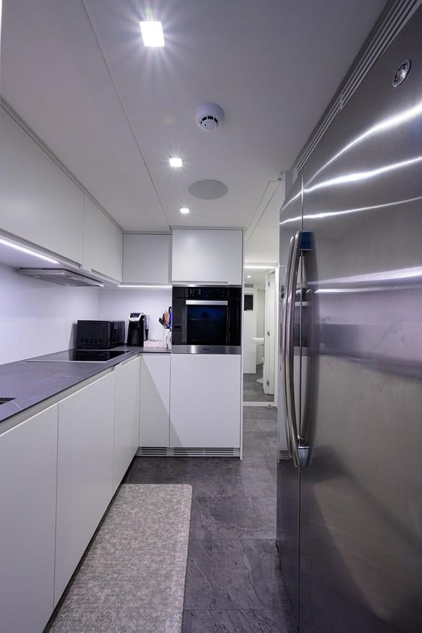 a kitchen with white cabinets aboard ON THE MOVE Yacht for Sale