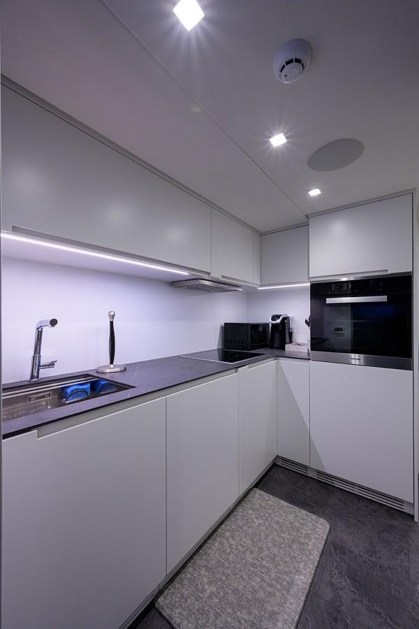 a kitchen with white cabinets aboard ON THE MOVE Yacht for Sale
