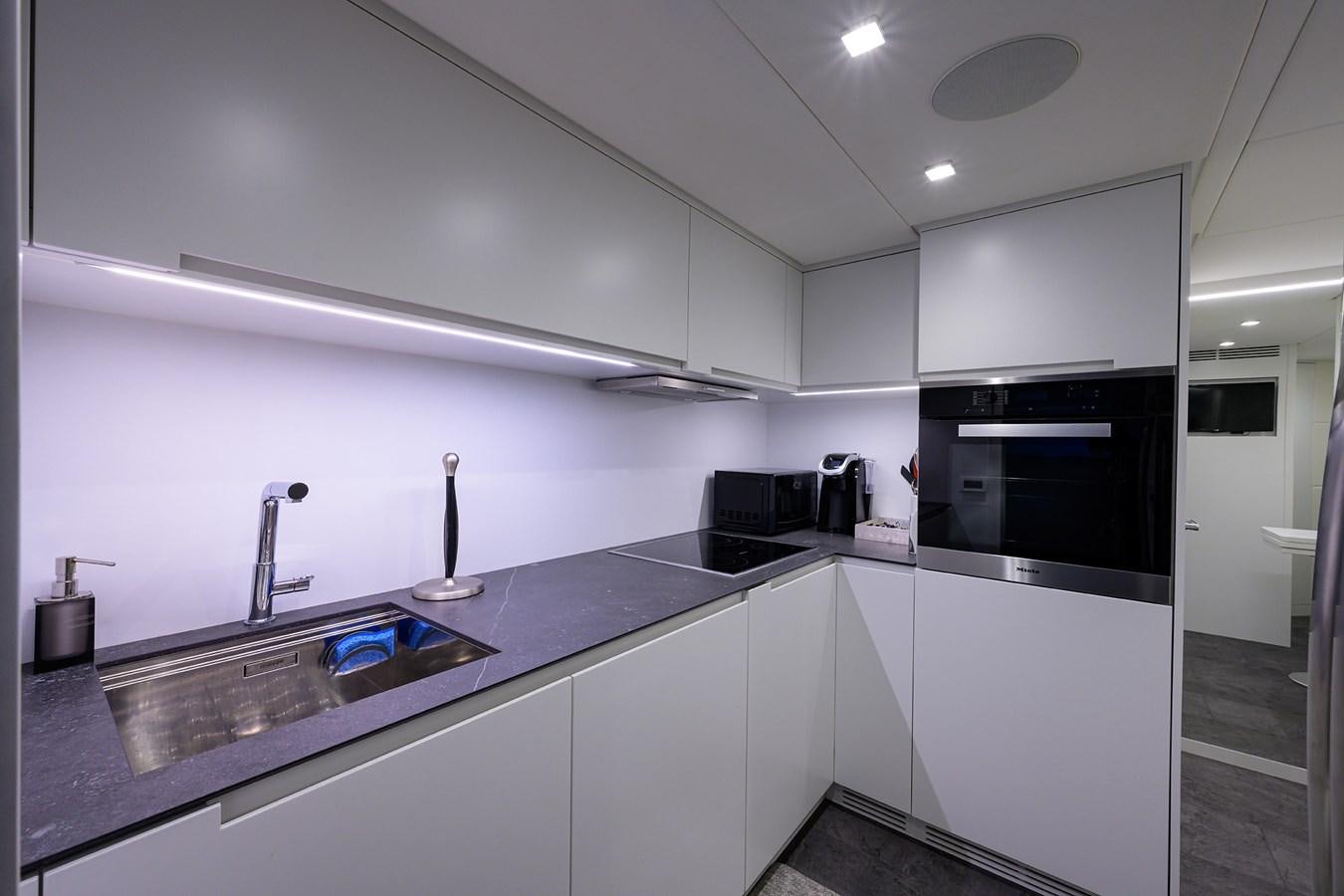 a kitchen with a countertop sink and cabinets aboard ON THE MOVE Yacht for Sale
