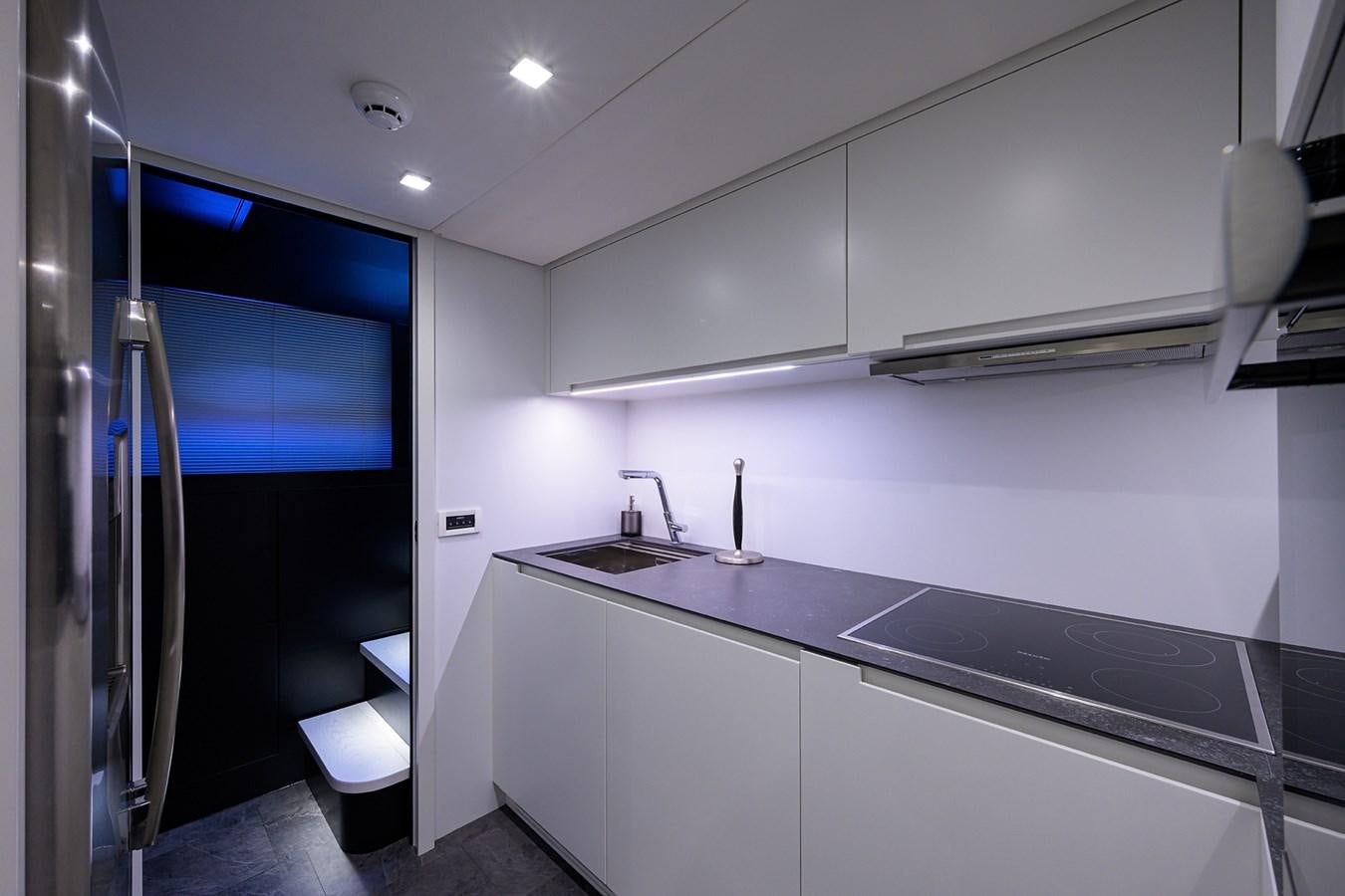 a kitchen with a sink and a refrigerator aboard ON THE MOVE Yacht for Sale