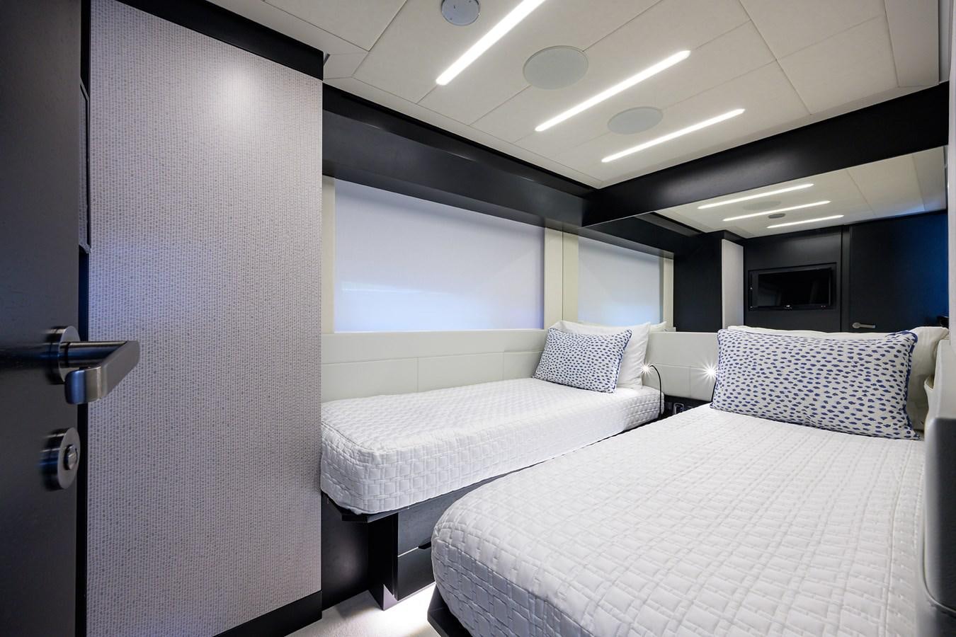 a room with a couple of beds aboard ON THE MOVE Yacht for Sale
