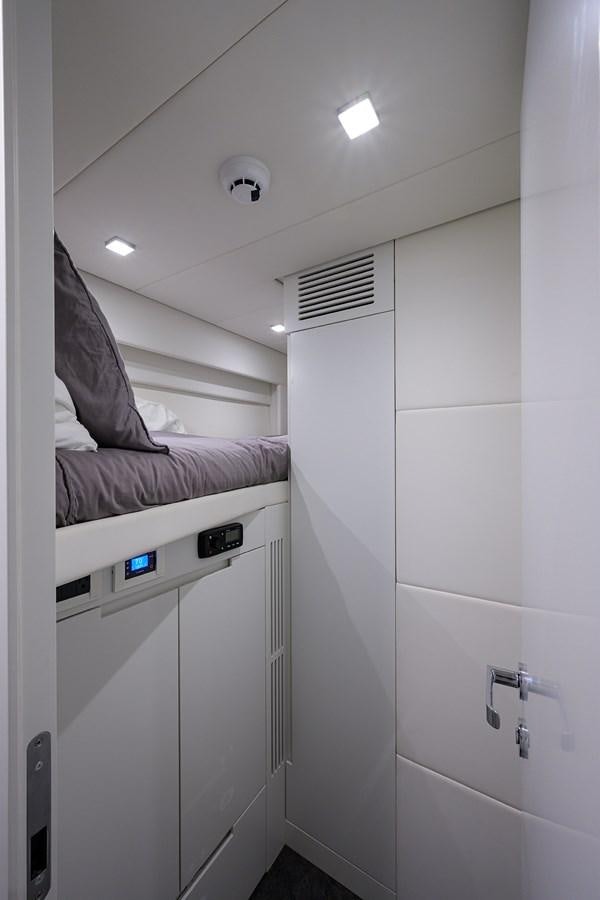 a white room with a bed and a white wall aboard ON THE MOVE Yacht for Sale