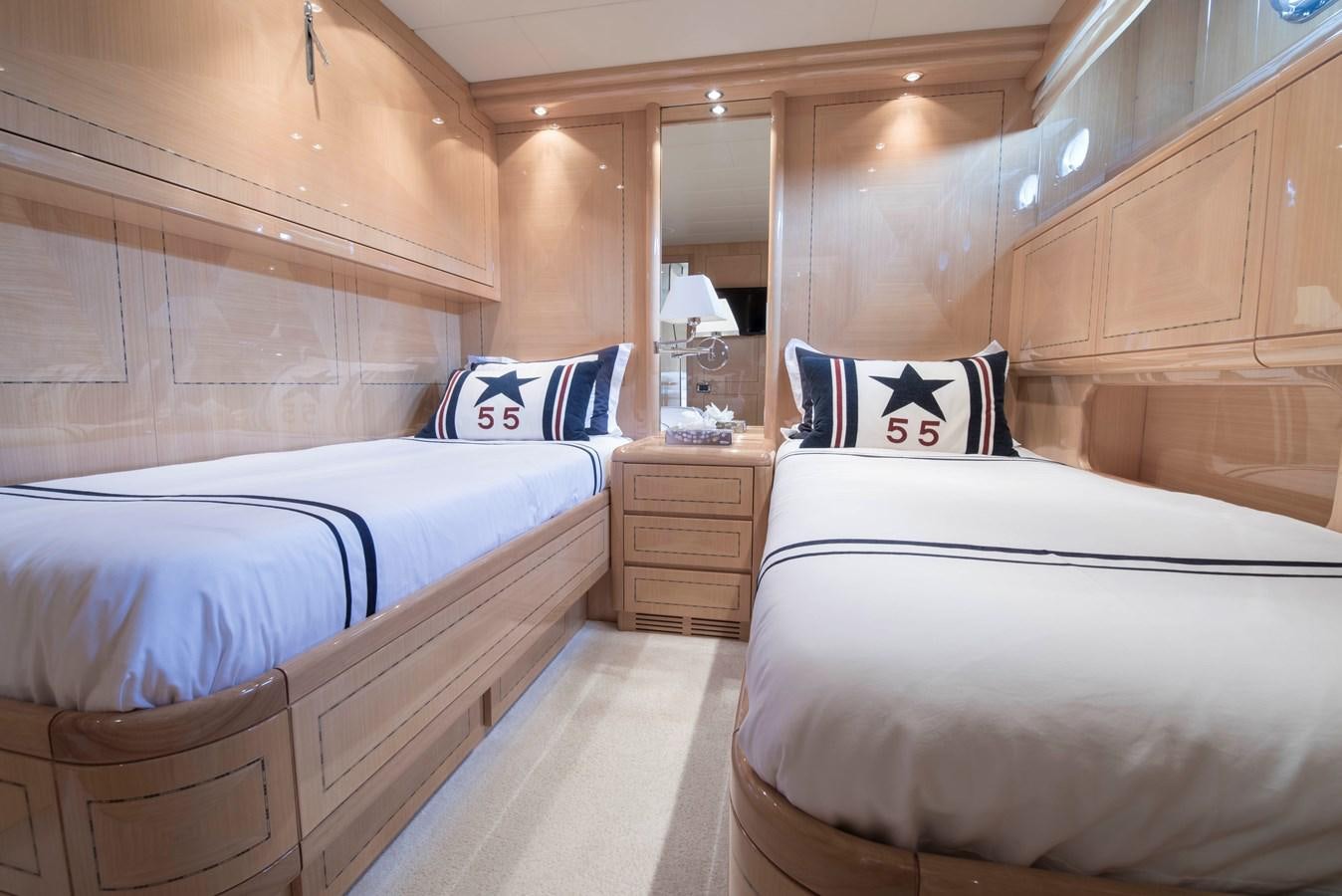 a room with beds and a wood cabinet aboard TAKE OFF Yacht for Sale