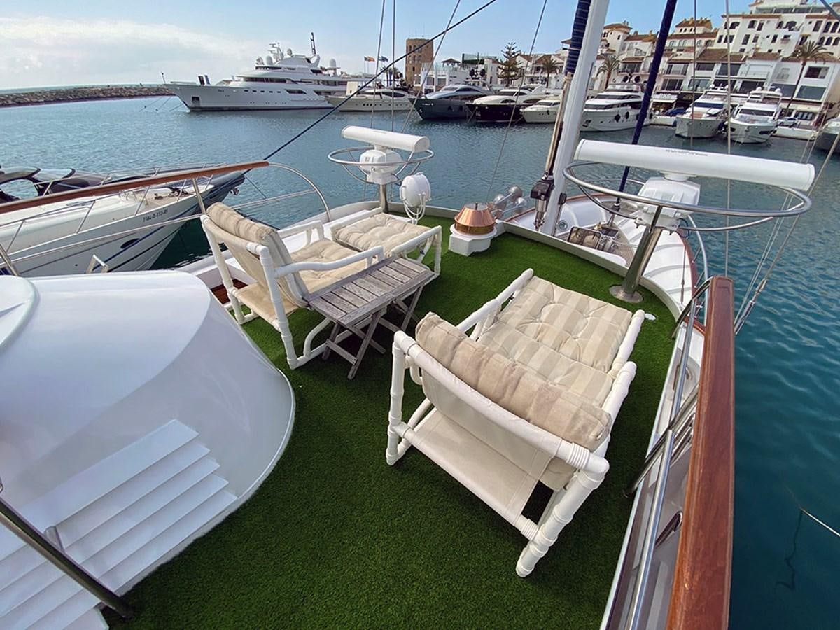 a boat dock with chairs and tables aboard COLUMBUS OF LYMINGTON Yacht for Sale