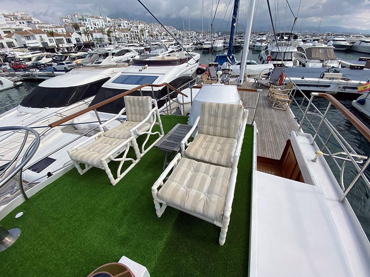 a group of chairs on a deck overlooking a city aboard COLUMBUS OF LYMINGTON Yacht for Sale