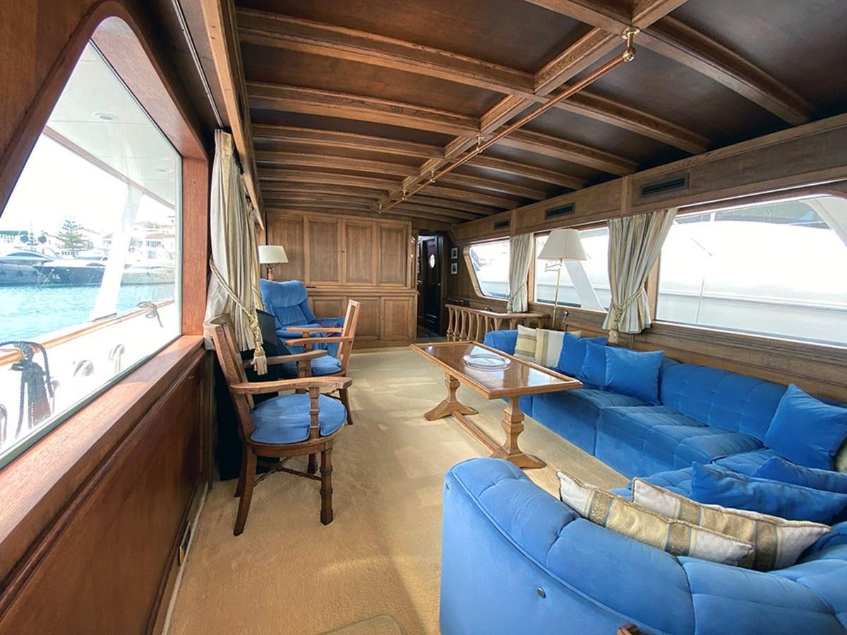 a living room with a large window aboard COLUMBUS OF LYMINGTON Yacht for Sale