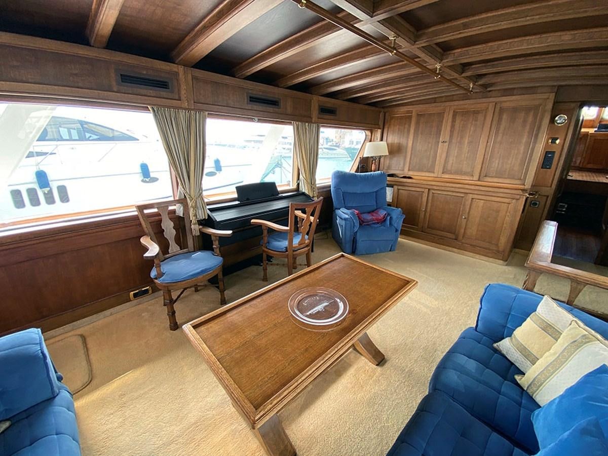 a room with a table chairs and a couch aboard COLUMBUS OF LYMINGTON Yacht for Sale