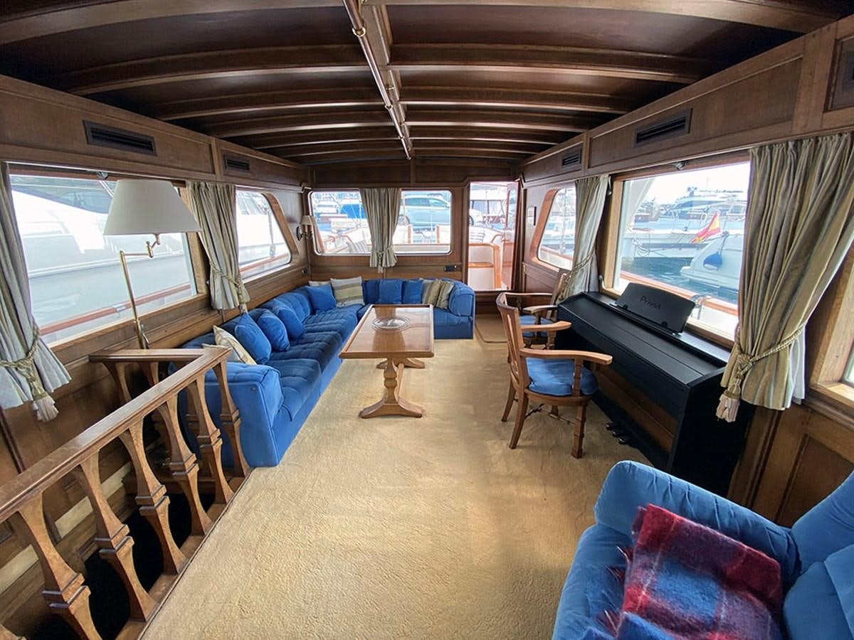 a train with a couch and a table and chairs aboard COLUMBUS OF LYMINGTON Yacht for Sale