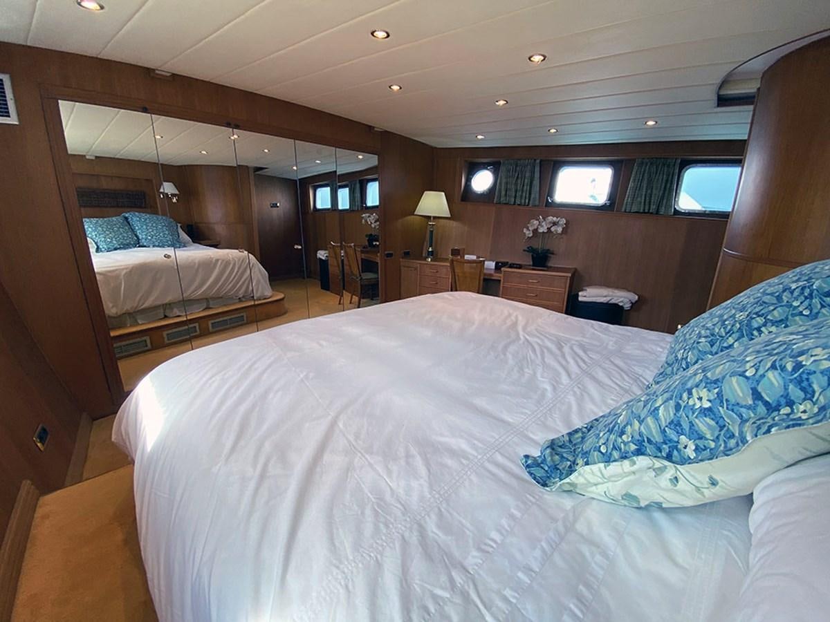 a room with a bed and a desk aboard COLUMBUS OF LYMINGTON Yacht for Sale