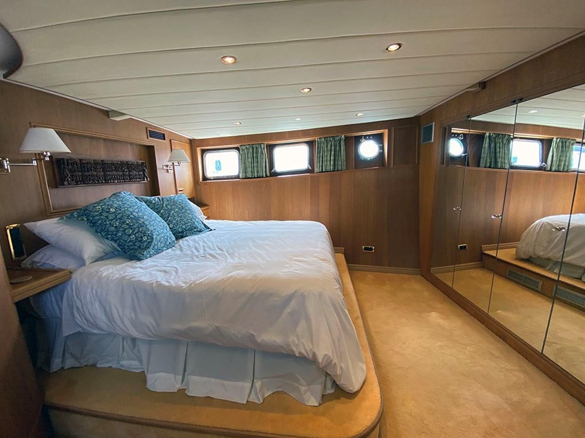 a room with a bed and a desk aboard COLUMBUS OF LYMINGTON Yacht for Sale