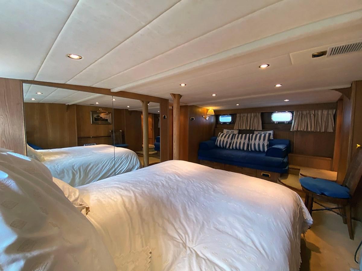 a room with a bed and a couch aboard COLUMBUS OF LYMINGTON Yacht for Sale