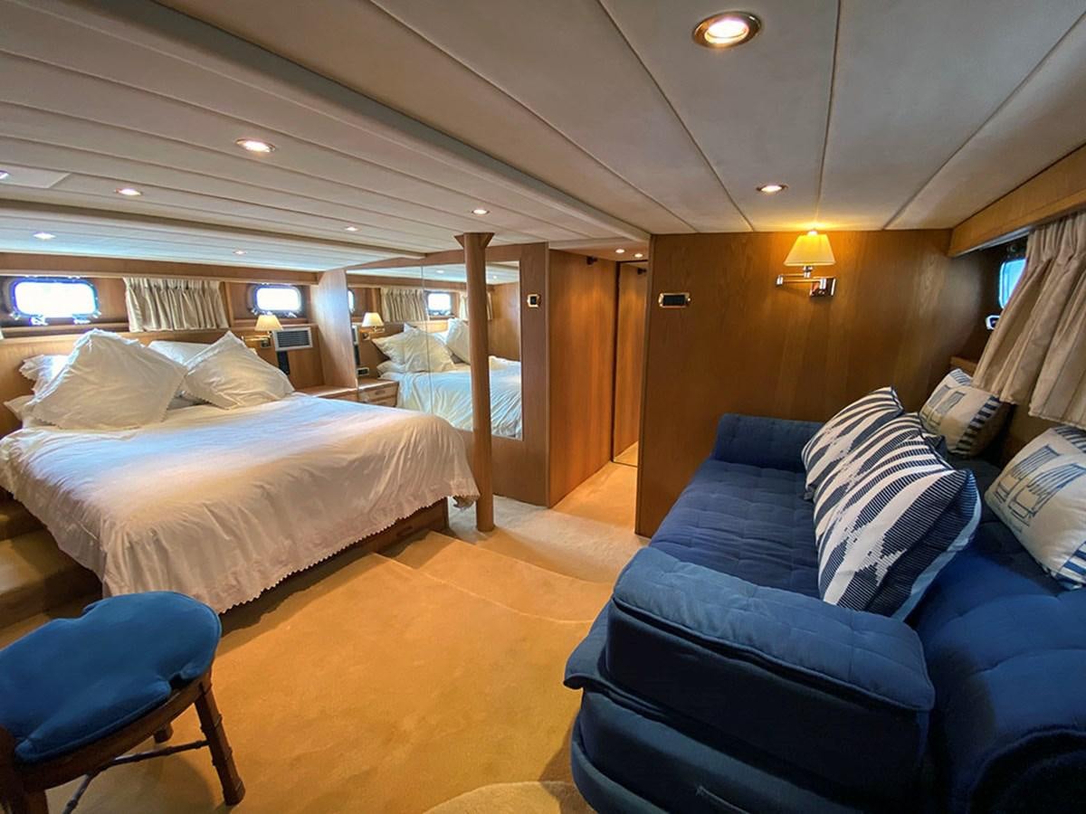 a bedroom with a bed and a couch aboard COLUMBUS OF LYMINGTON Yacht for Sale