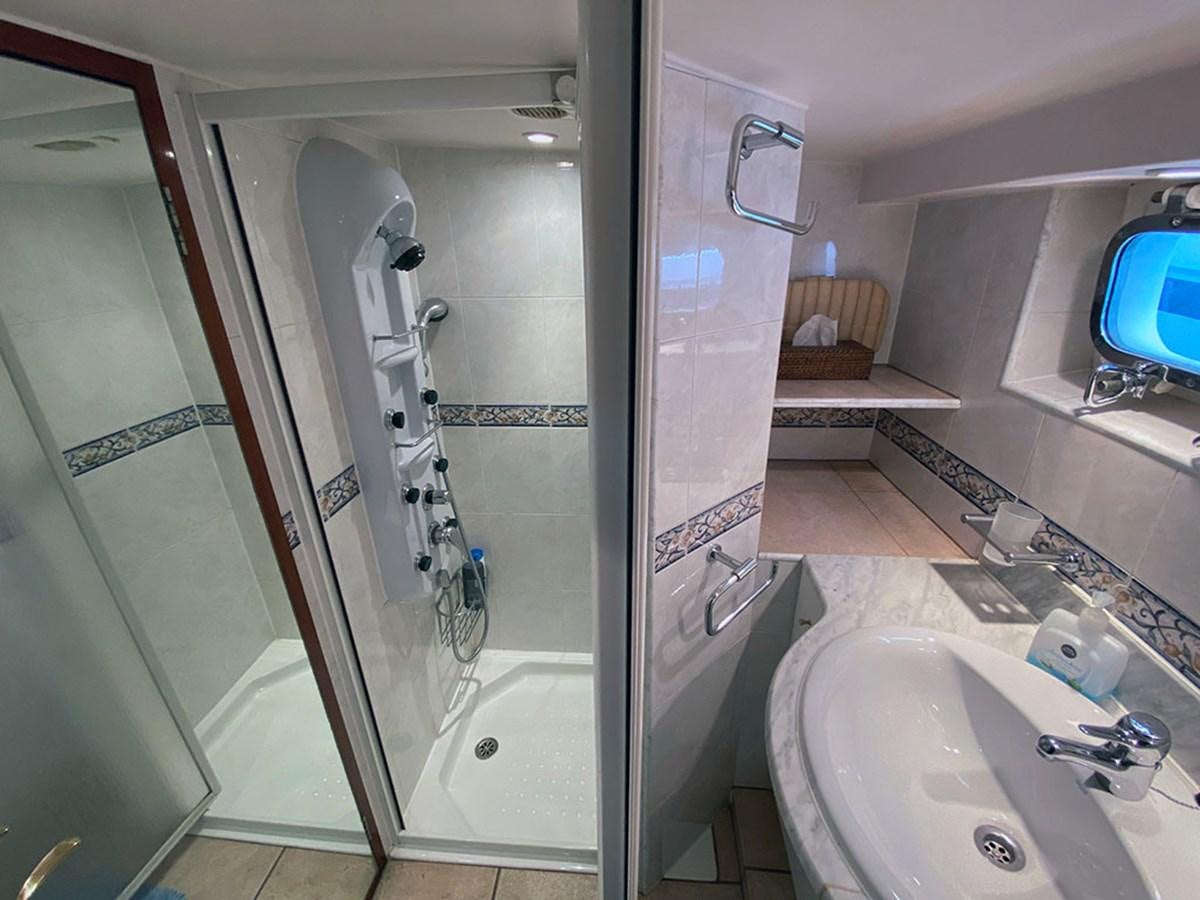 a bathroom with a sink and a shower aboard COLUMBUS OF LYMINGTON Yacht for Sale
