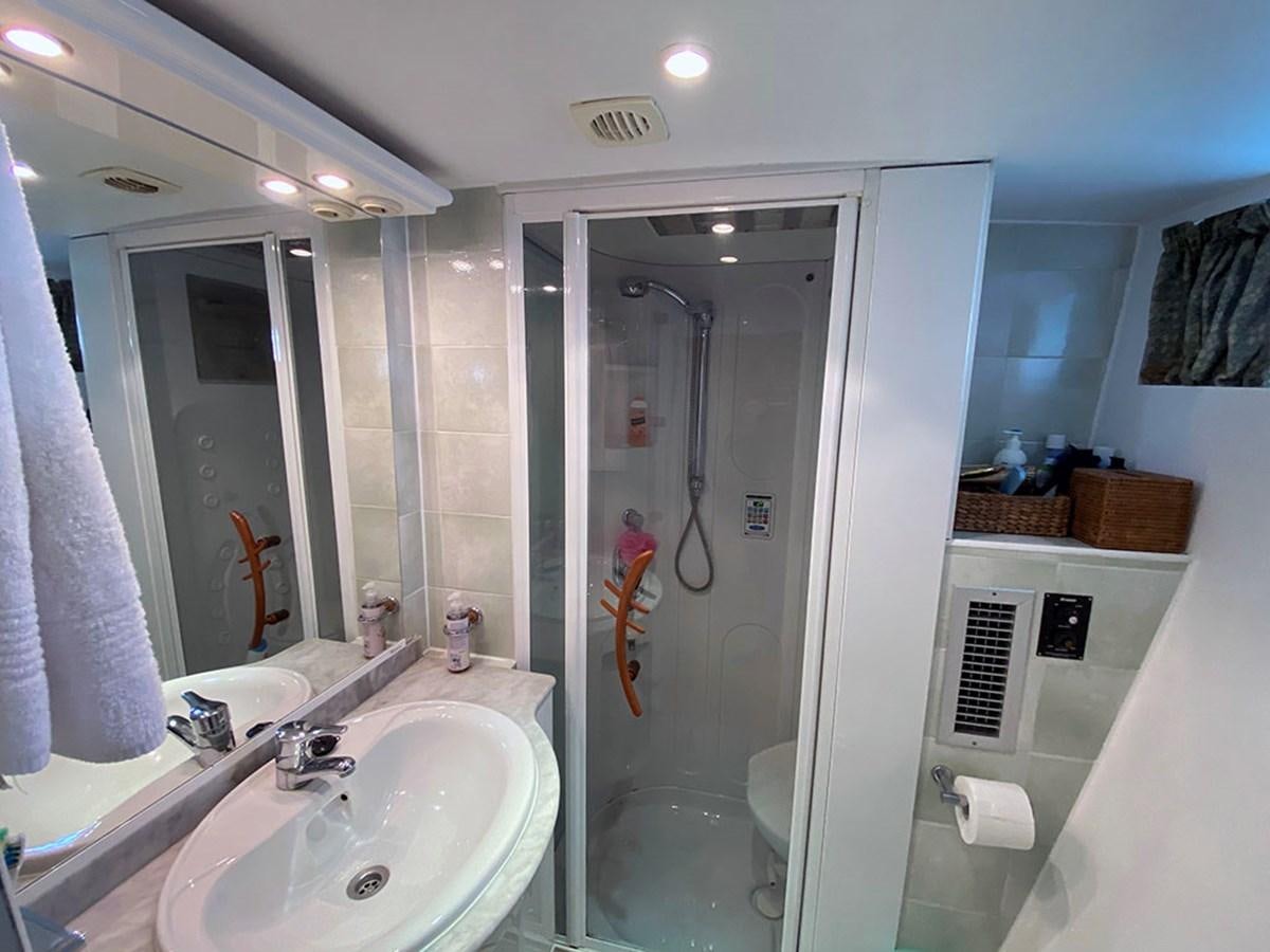 a bathroom with a shower and sink aboard COLUMBUS OF LYMINGTON Yacht for Sale
