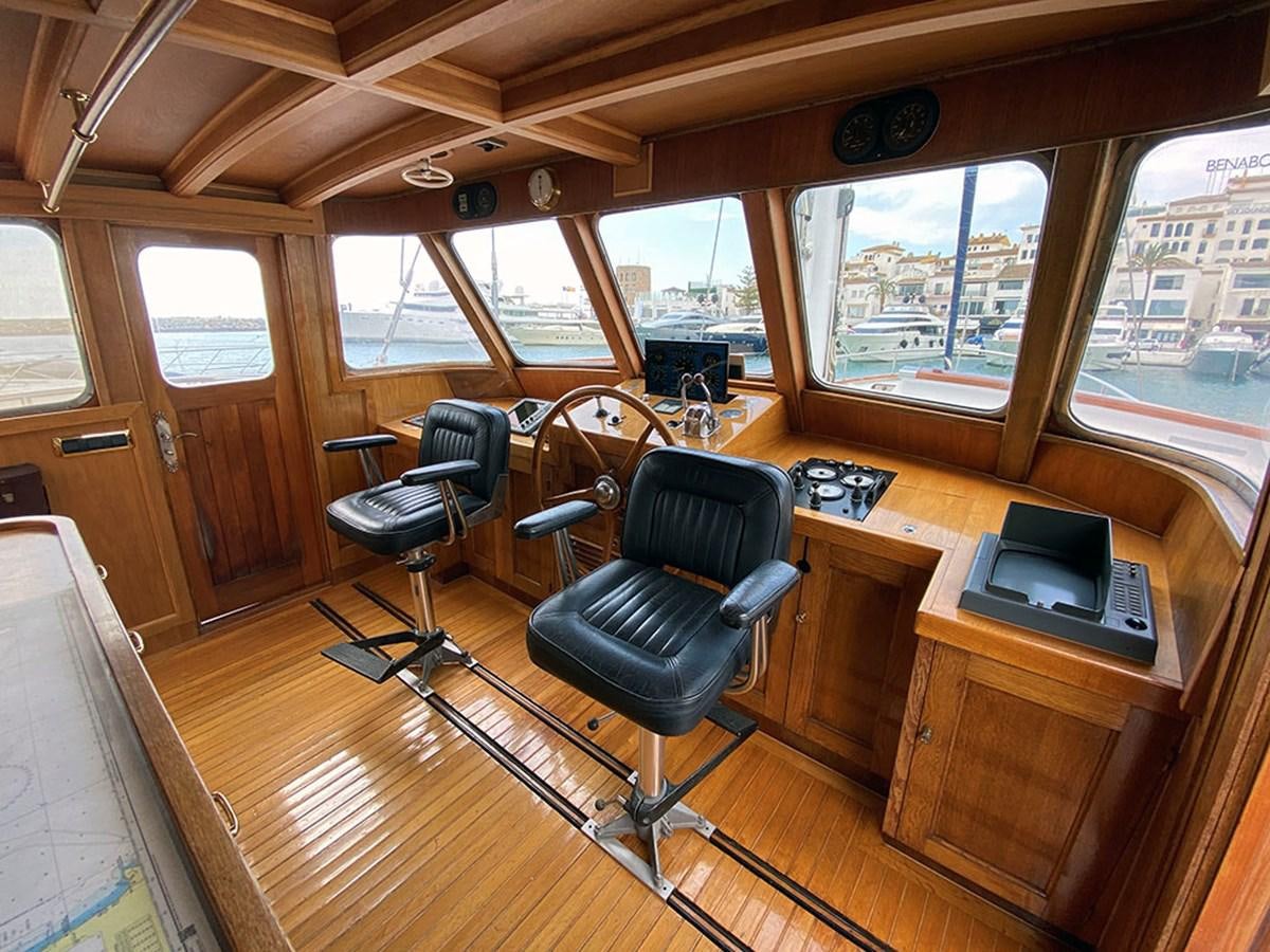 a room with a desk and chairs aboard COLUMBUS OF LYMINGTON Yacht for Sale