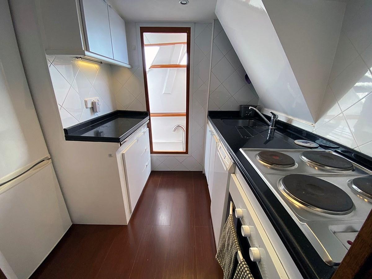 a kitchen with a stove and sink aboard COLUMBUS OF LYMINGTON Yacht for Sale