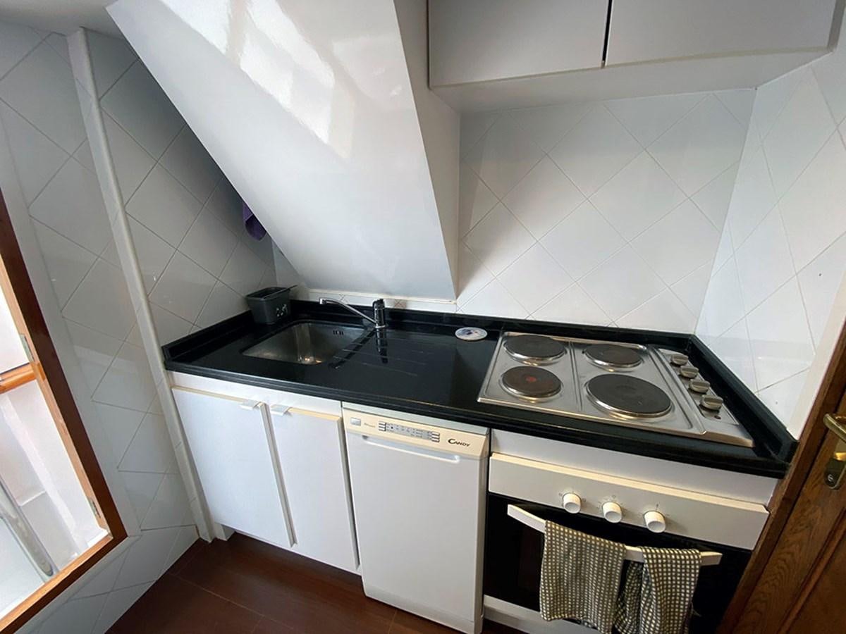 a kitchen with white cabinets aboard COLUMBUS OF LYMINGTON Yacht for Sale