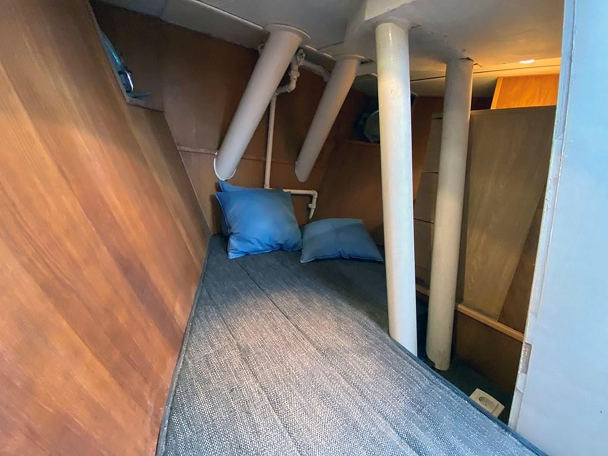 a bed with a blue pillow aboard COLUMBUS OF LYMINGTON Yacht for Sale