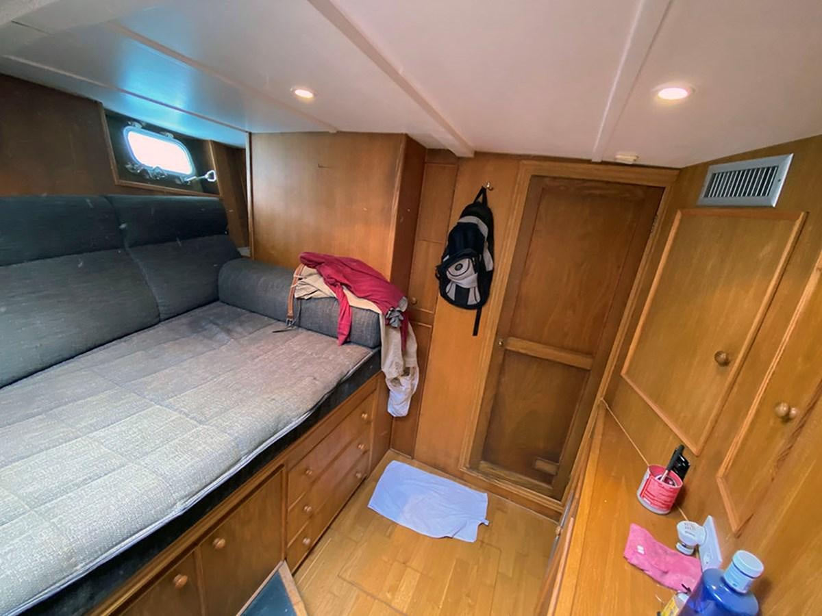 a bedroom with a bed and a couch aboard COLUMBUS OF LYMINGTON Yacht for Sale