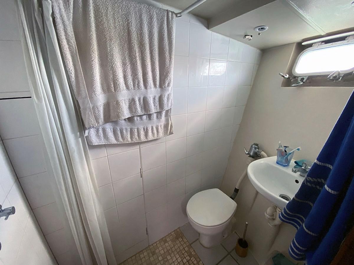 a bathroom with a toilet and sink aboard COLUMBUS OF LYMINGTON Yacht for Sale