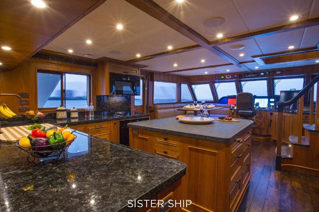 a large kitchen with a large island aboard 820 CPMY Yacht for Sale